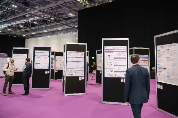 Conference attendees networking and discussing research at poster displays during World ADC London.